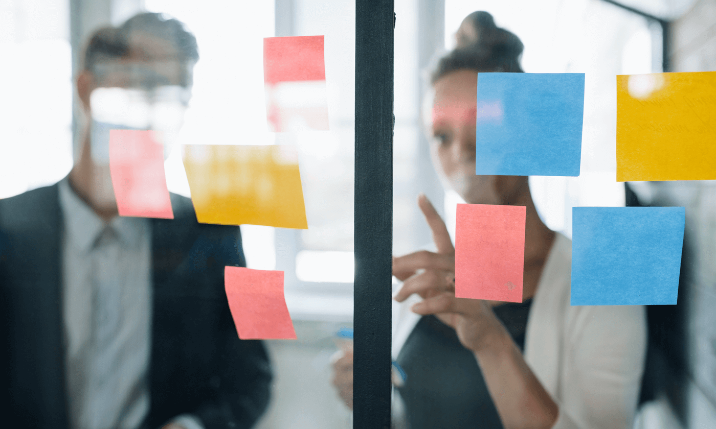 woman and man checking out the sticky notes