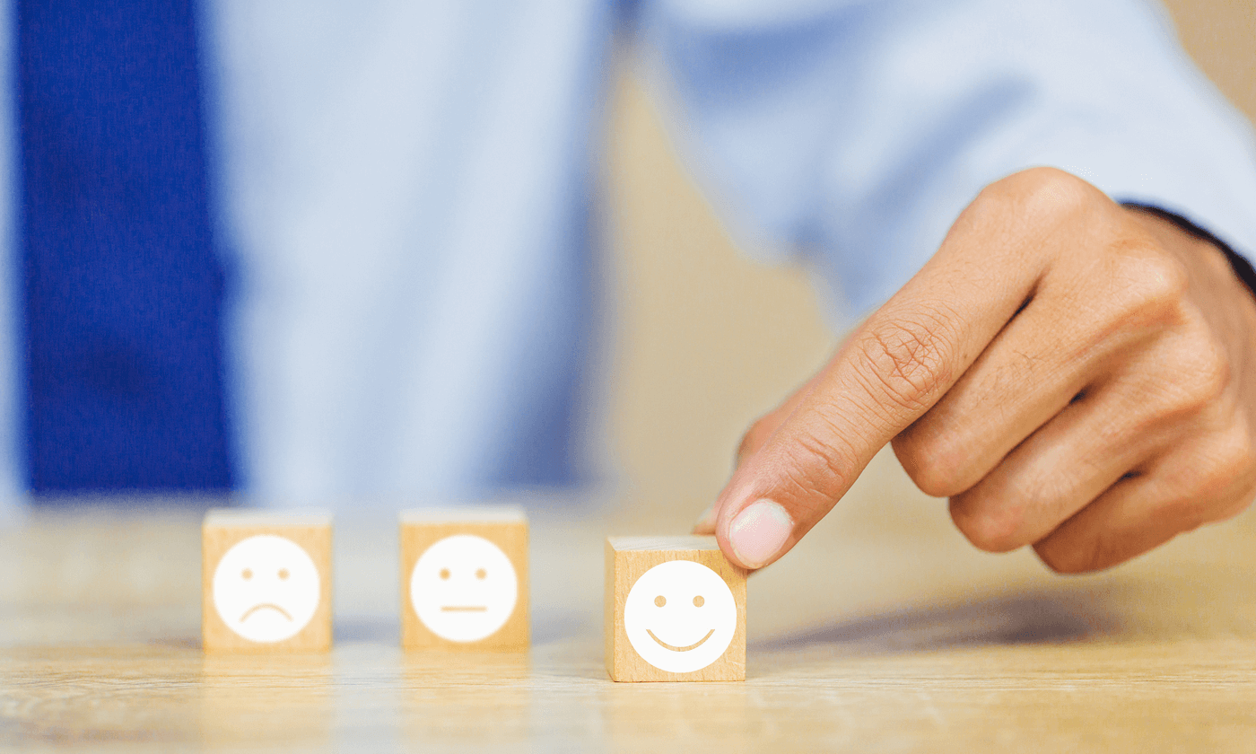 man lifting a smile emoji on the wood