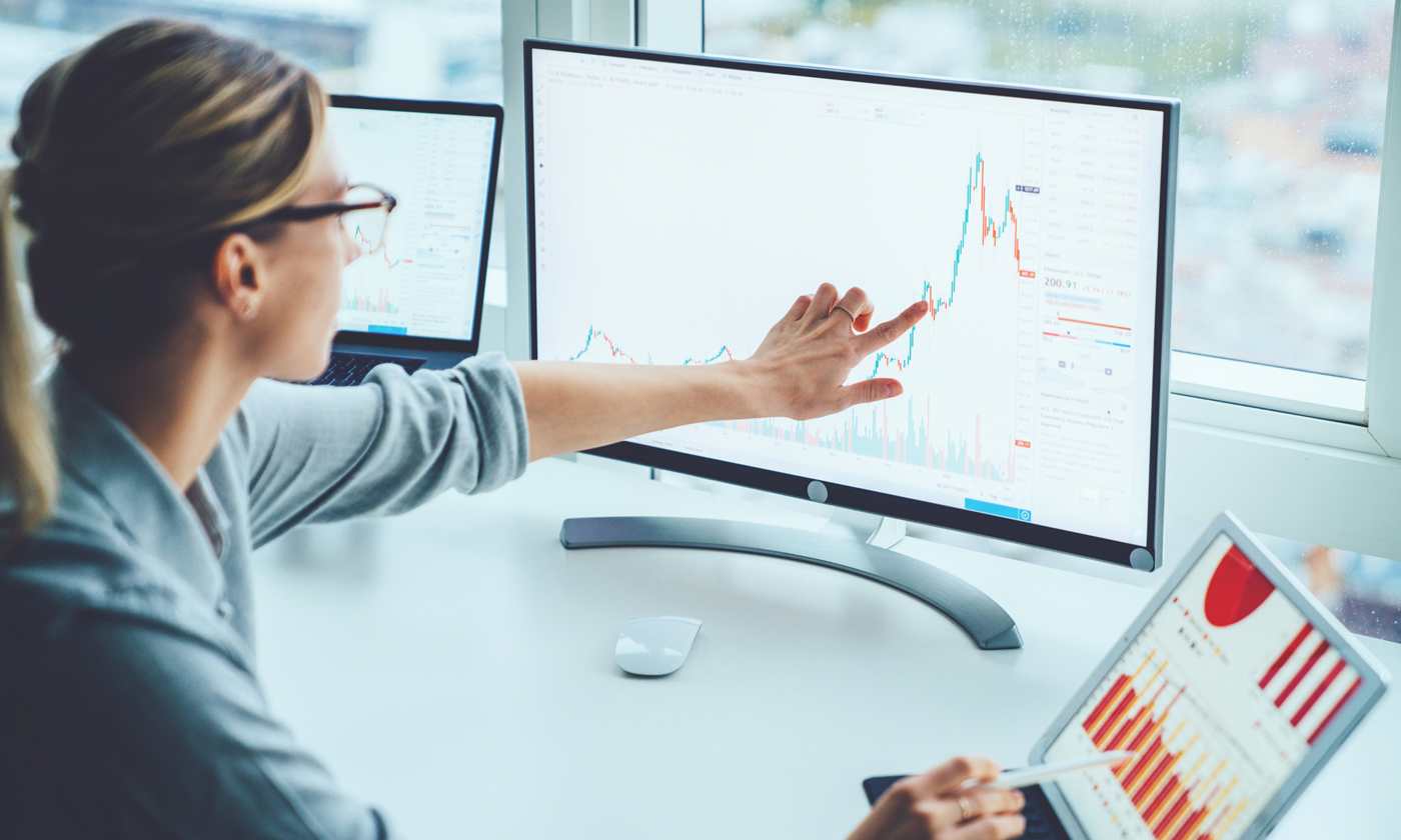 woman touching the monitor with the chart on it