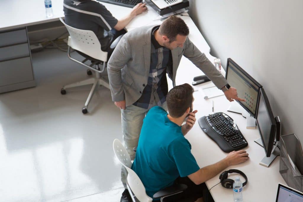 employees in office collaborating at computer