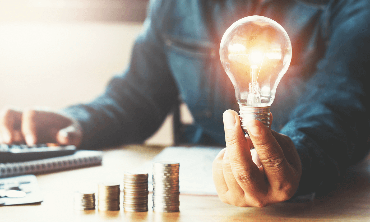 man holding a shining lightbulb