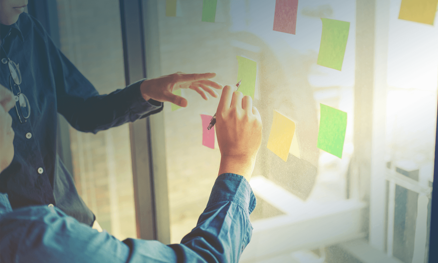 man pointing something on the sticky note