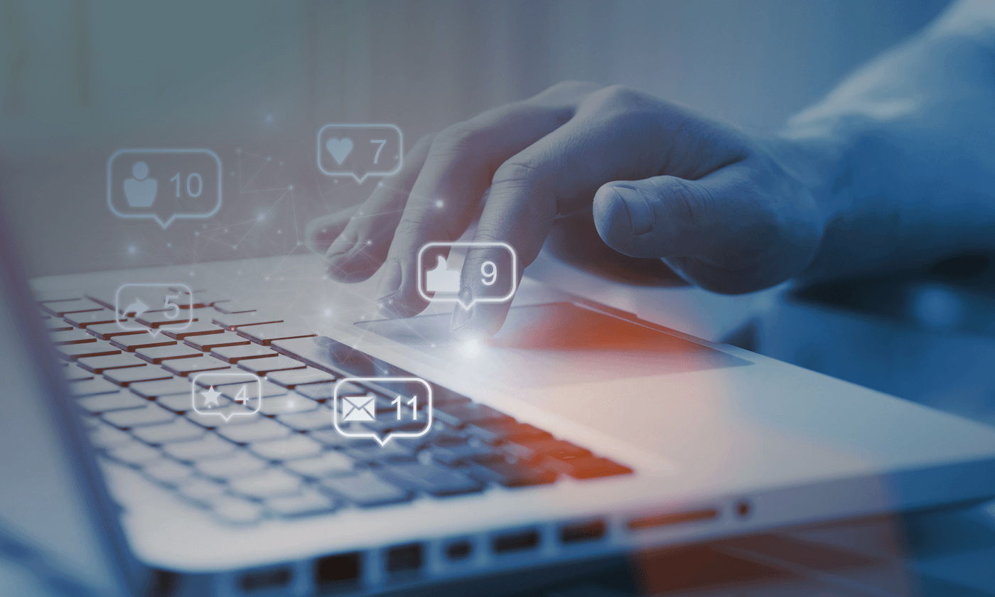 man tapping on the touchpad with social media reactions overlay