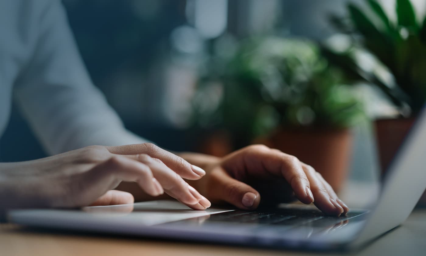 person typing on a laptop