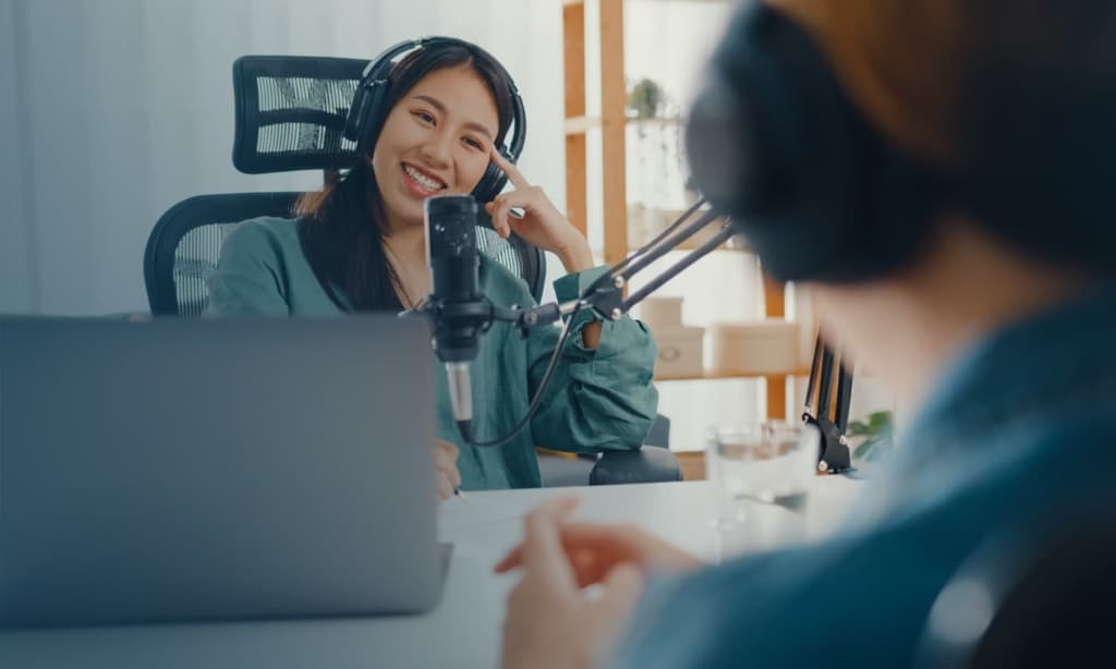 woman smiling on a headset and a microphone