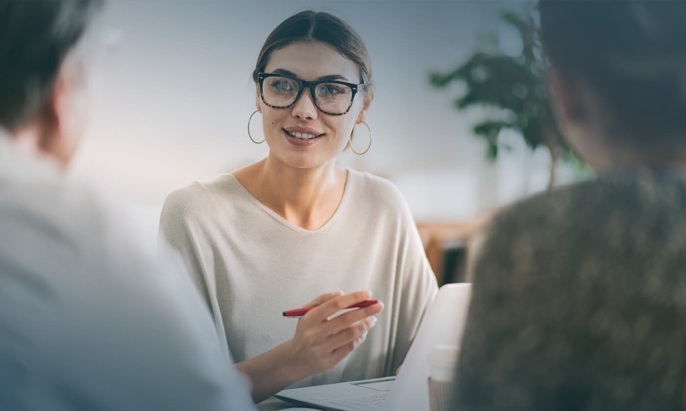 woman holding a pen having a discussion