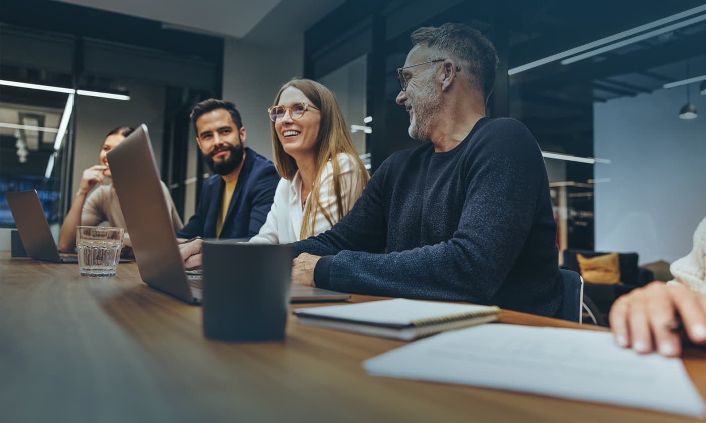 team smiling while having a meeting