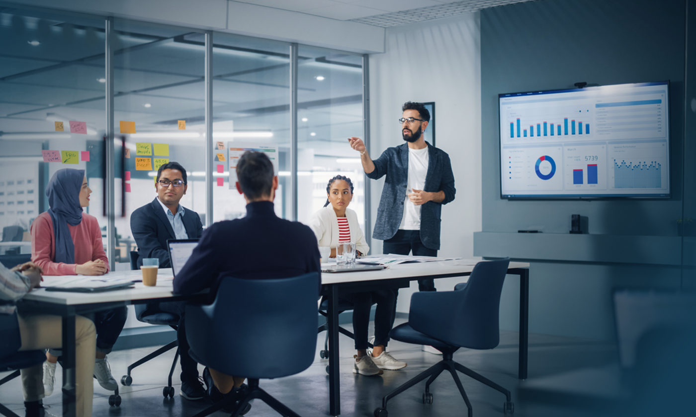 business meeting with analytics and graphs displayed on the screen