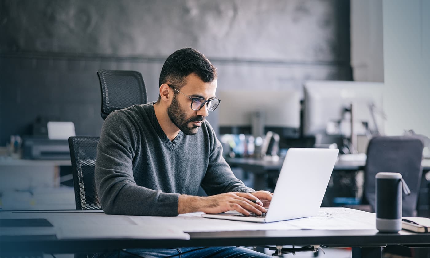 man working on laptop in an office