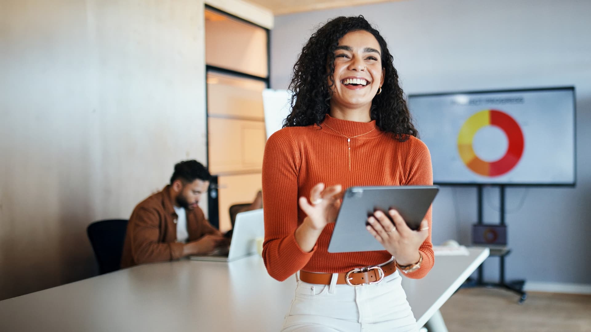 woman smiling holding a tablet